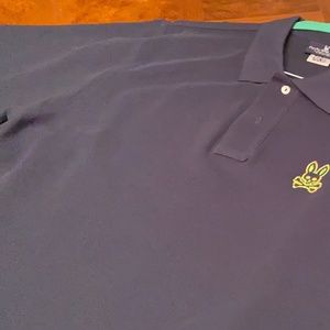 Men’s size 8 Psycho Bunny navypolo with bright green trim and multicolored logo